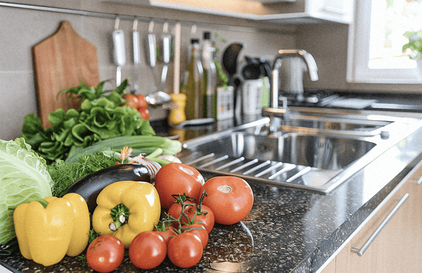 row of vegetables in kitchen counter