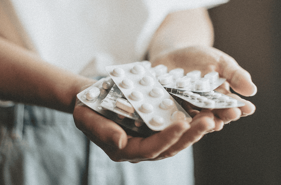 hand holding a bunch of medication together