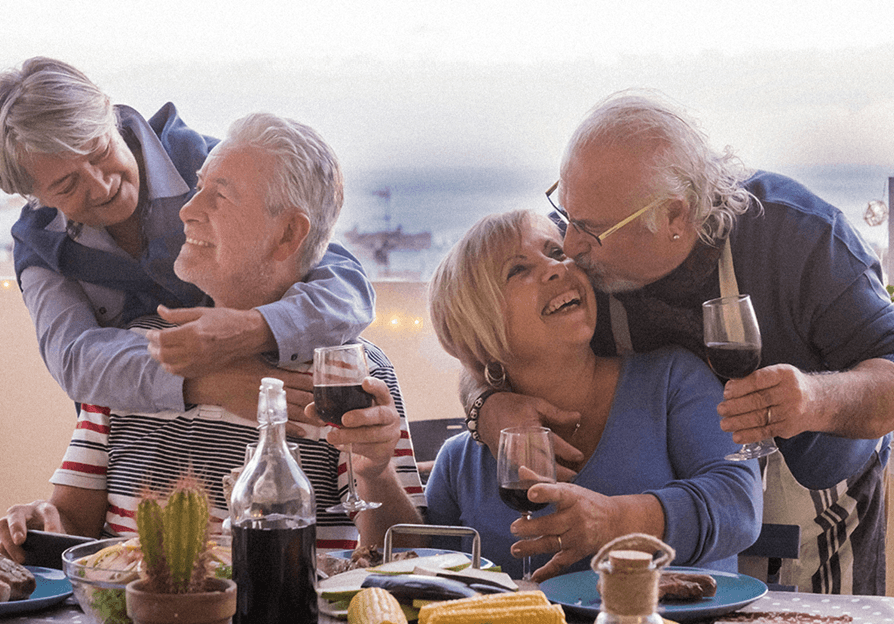 two senior couples having fun at dinner