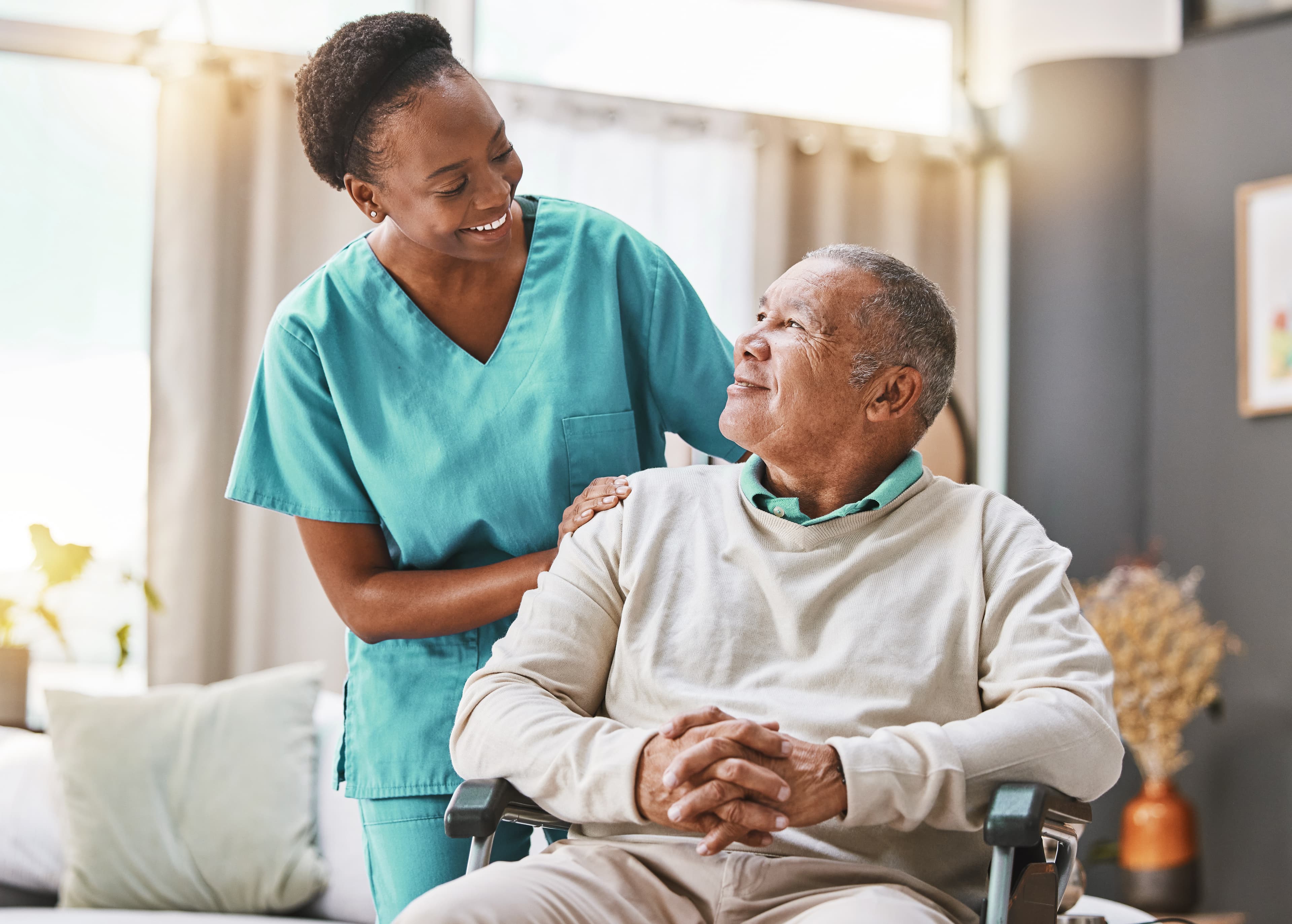 Caregiver providing companionship and daily living support to a senior at home